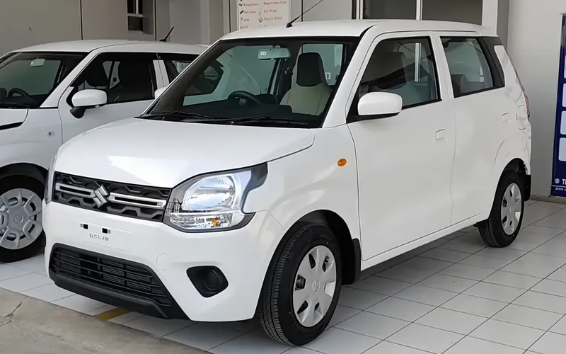 White Maruti Suzuki Wagon R hatchback taxi parked, front three-quarter view