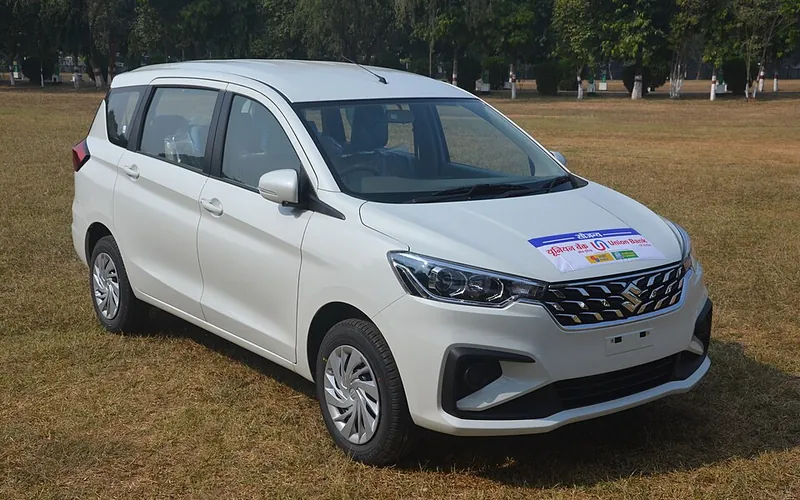 White Maruti Suzuki Ertiga seven seater MUV taxi, front three-quarter view