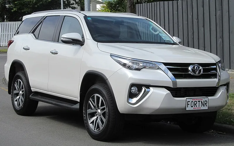 White Toyota Fortuner luxury SUV taxi, front three-quarter view