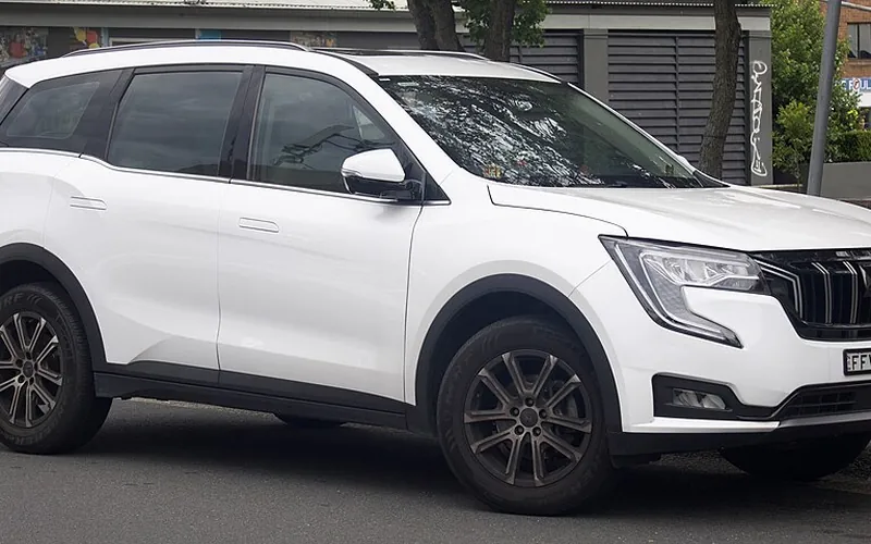 White Mahindra XUV700 SUV taxi, front three-quarter view